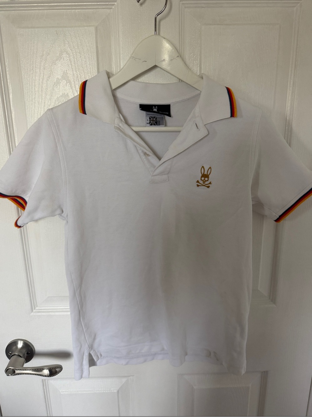 Psycho Bunny White Polo with Gold Bunny and Red-Orange-Blue Trim